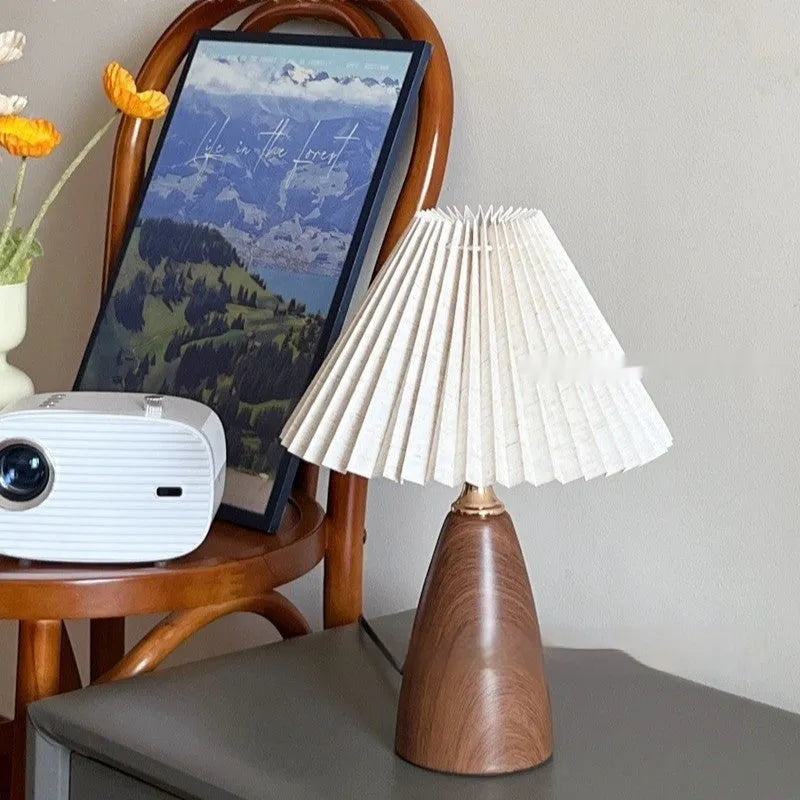 Nordic retro ceramic bedside table lamp with a pleated tapered floral fabric shade on a ceramic base.