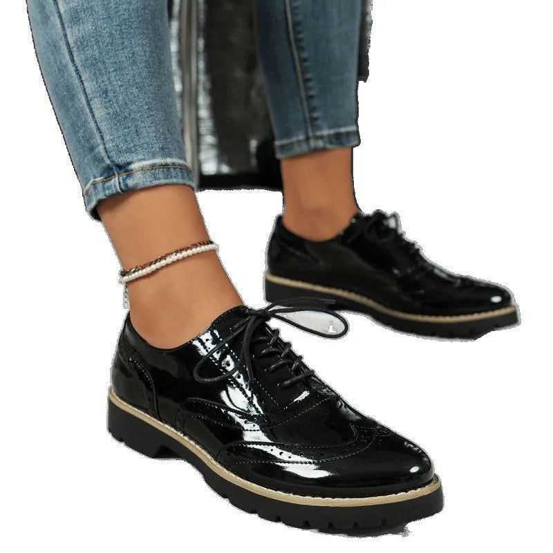 Women's black PU oxford loafers with a wedge heel and sequin details, showing lace-up front.