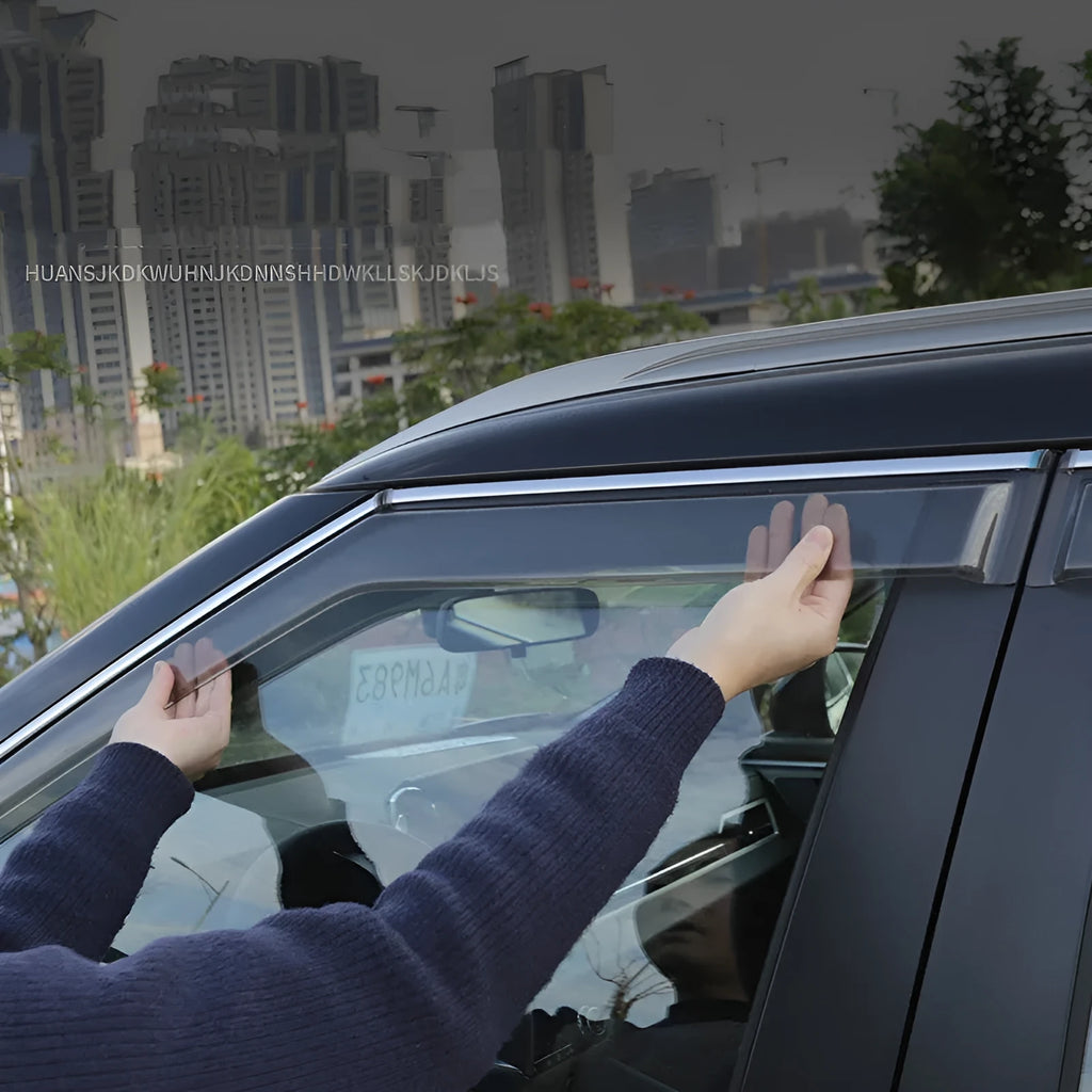 Black and translucent plastic window deflectors installed on a grey Mitsubishi Outlander SUV.