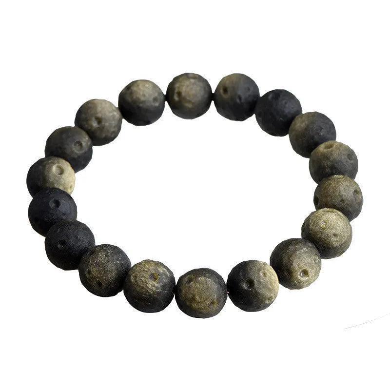 Natural obsidian crater ball bracelet with hand-ground texture, showing silver stone meteorite colour variation