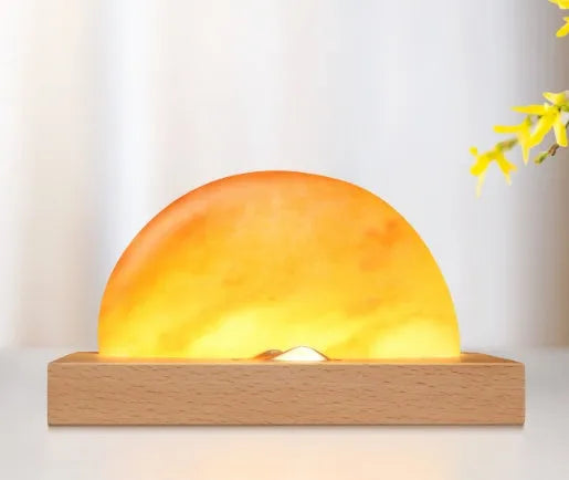 Wireless charging salt lamp with natural crystal salt shade on a solid beech wood base.