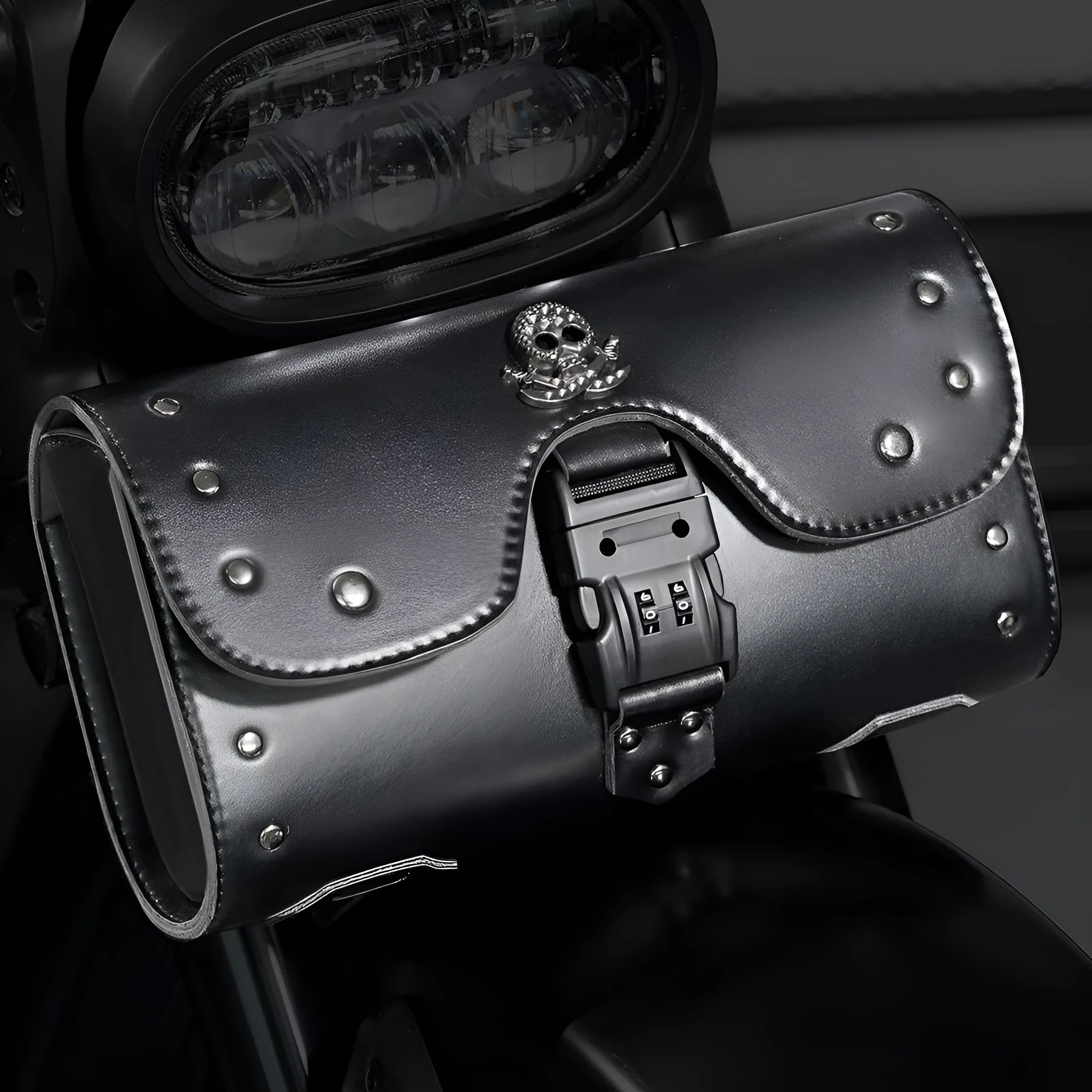 Black PU motorcycle pannier bag with punk retro styling mounted on a custom bike.
