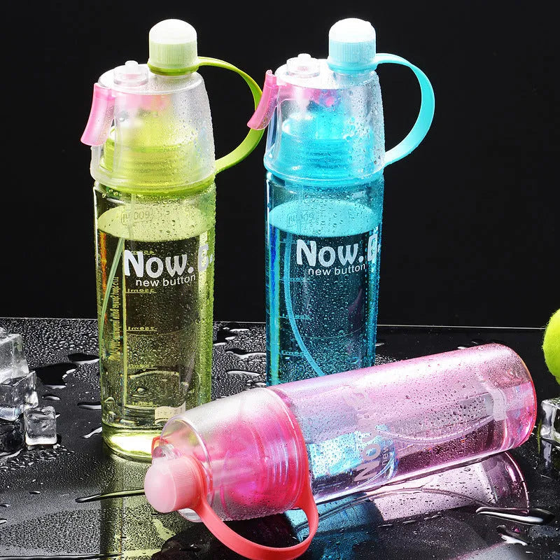 Portable outdoor mist spray water cup with transparent body, handle, and spray nozzle in green colour