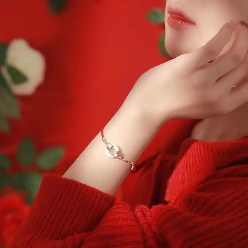 Women's red rope festive koi bracelet with peace buckle fastening and fishtail detailing