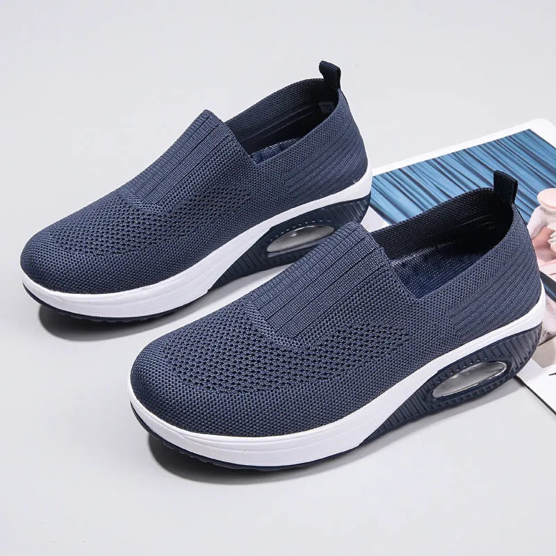 Women's mesh running shoes with air cushion technology in beige colour showing round toe shape and casual design