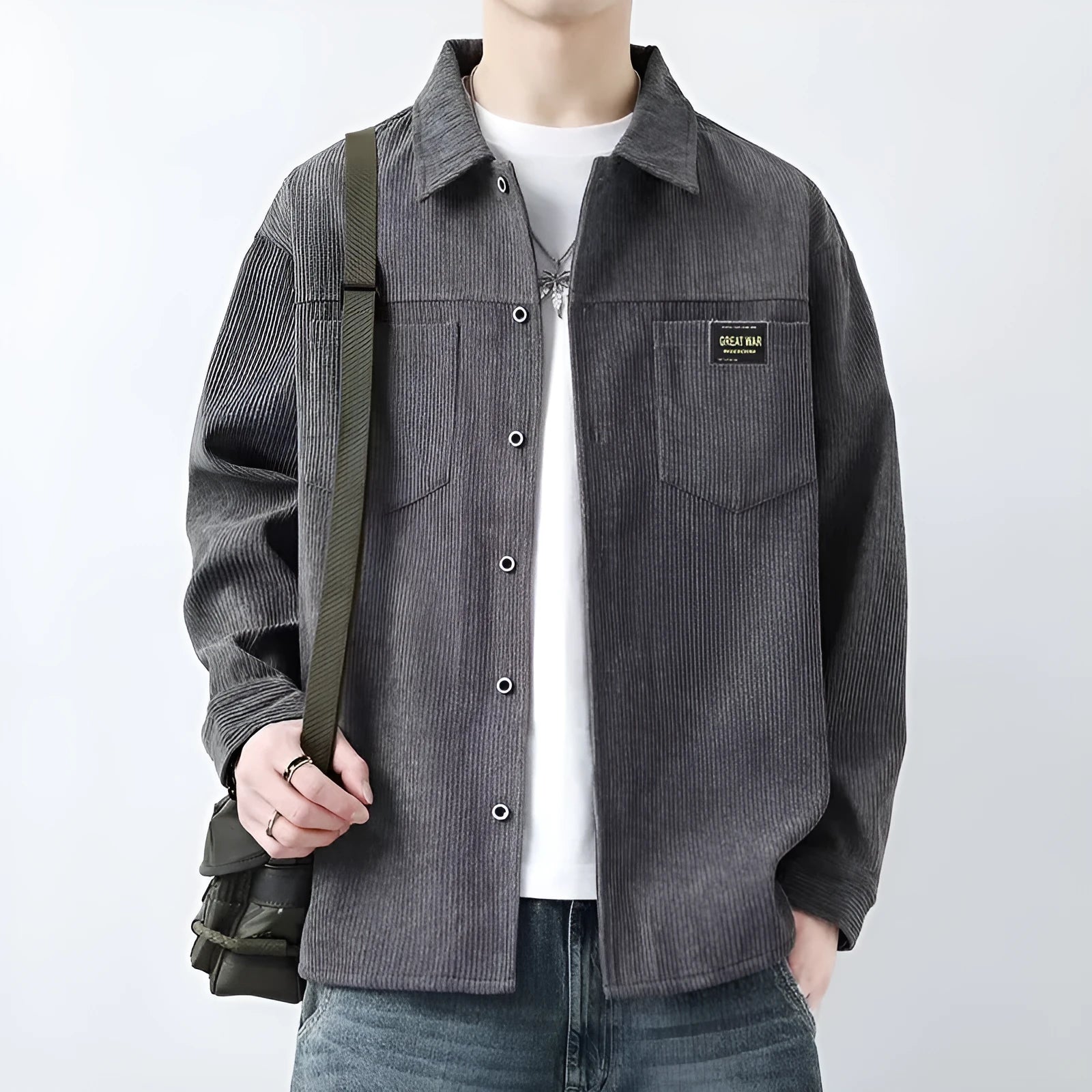 Men's black corduroy cardigan jacket with long sleeves laid flat