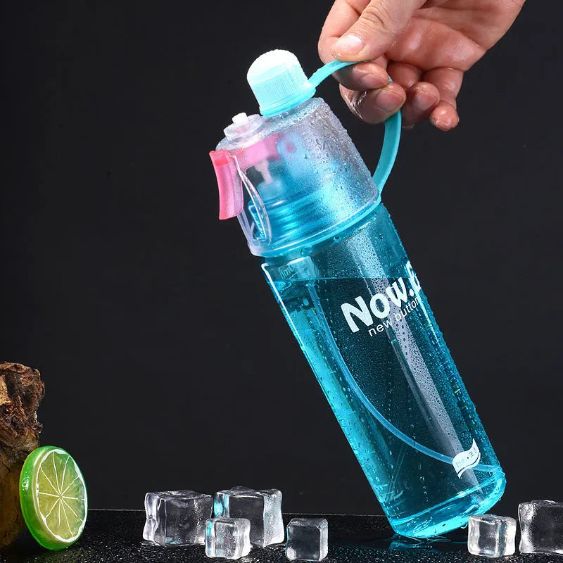 Portable outdoor mist spray water cup with transparent body, handle, and spray nozzle in green colour