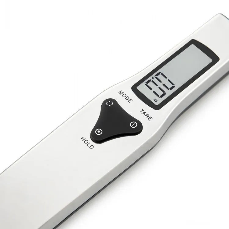 Digital measuring spoon with LCD display showing weight measurement