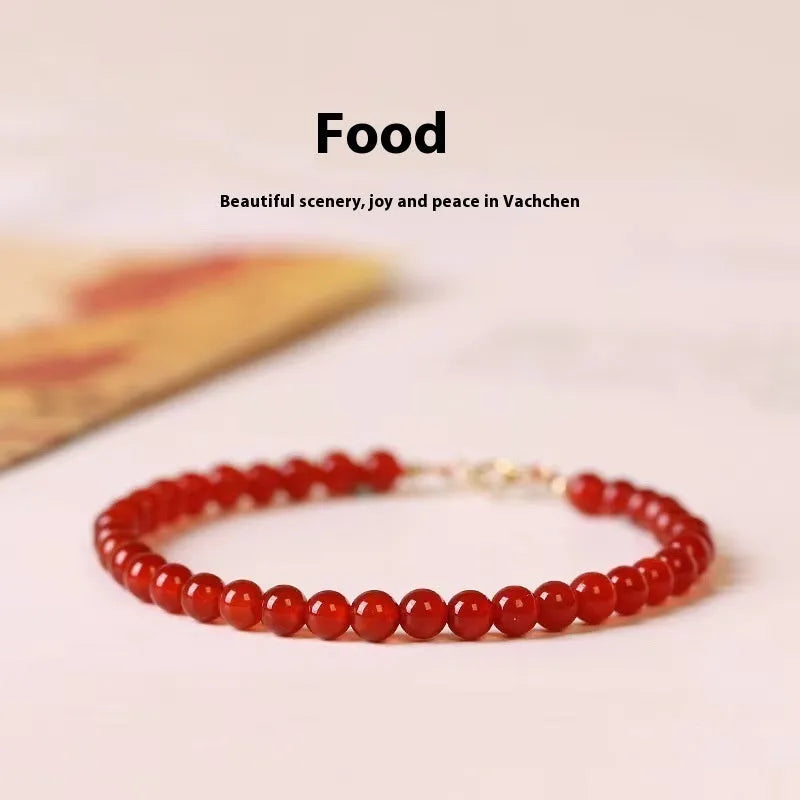 A red agate bracelet for women with an ultra-thin, delicate design on a wrist.
