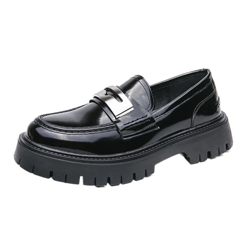 Men's black glossy PU leather loafers with a low platform sole, shown in a summer setting.