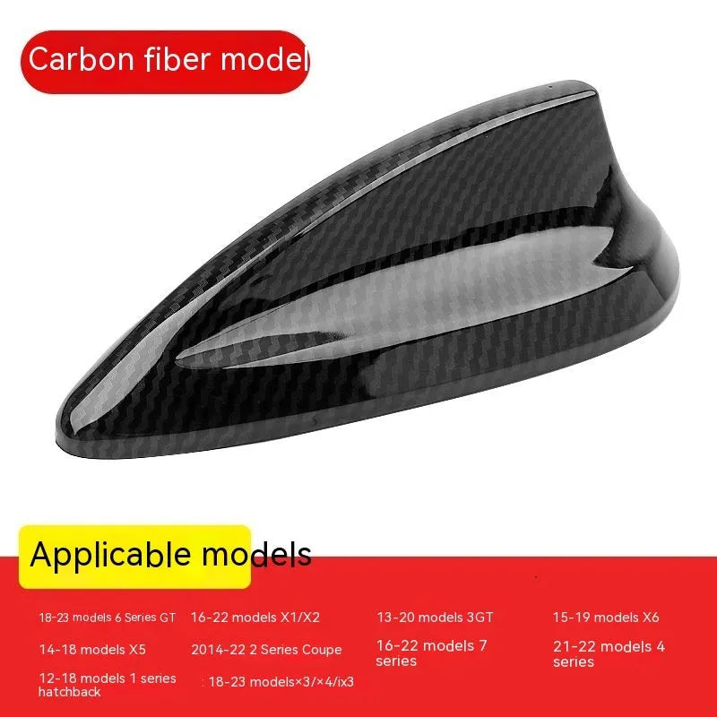 BMW shark fin antenna cover in carbon fibre and piano black finishes on a car roof.