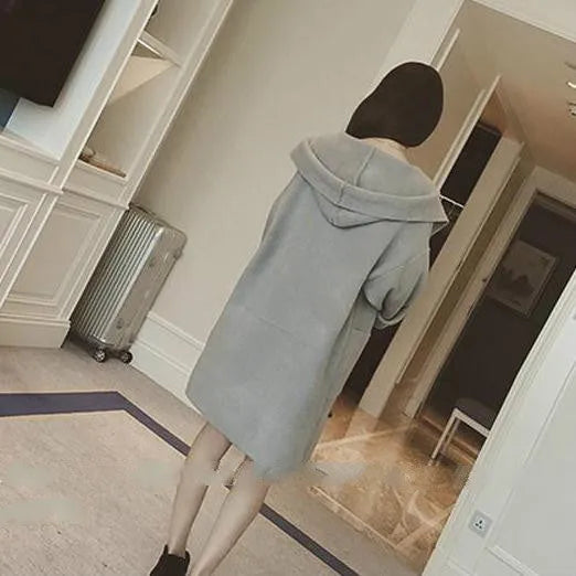 Plus size woman wearing a grey thin cotton coat with lace trim detail and long sleeves.