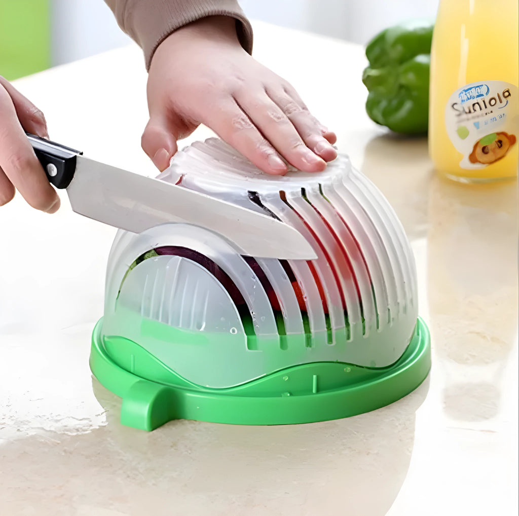 Blue BPA-free plastic salad cutter bowl with cutting grid lid on a white base with raised edges.