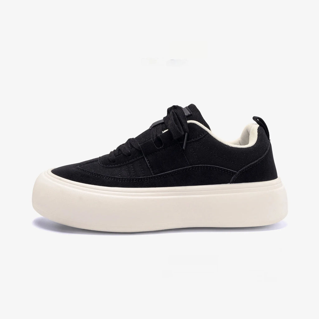 Men's black platform canvas shoes with round toe and lace-up front, showing raised heel design.