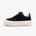 Men's black platform canvas shoes with round toe and lace-up front, showing raised heel design.