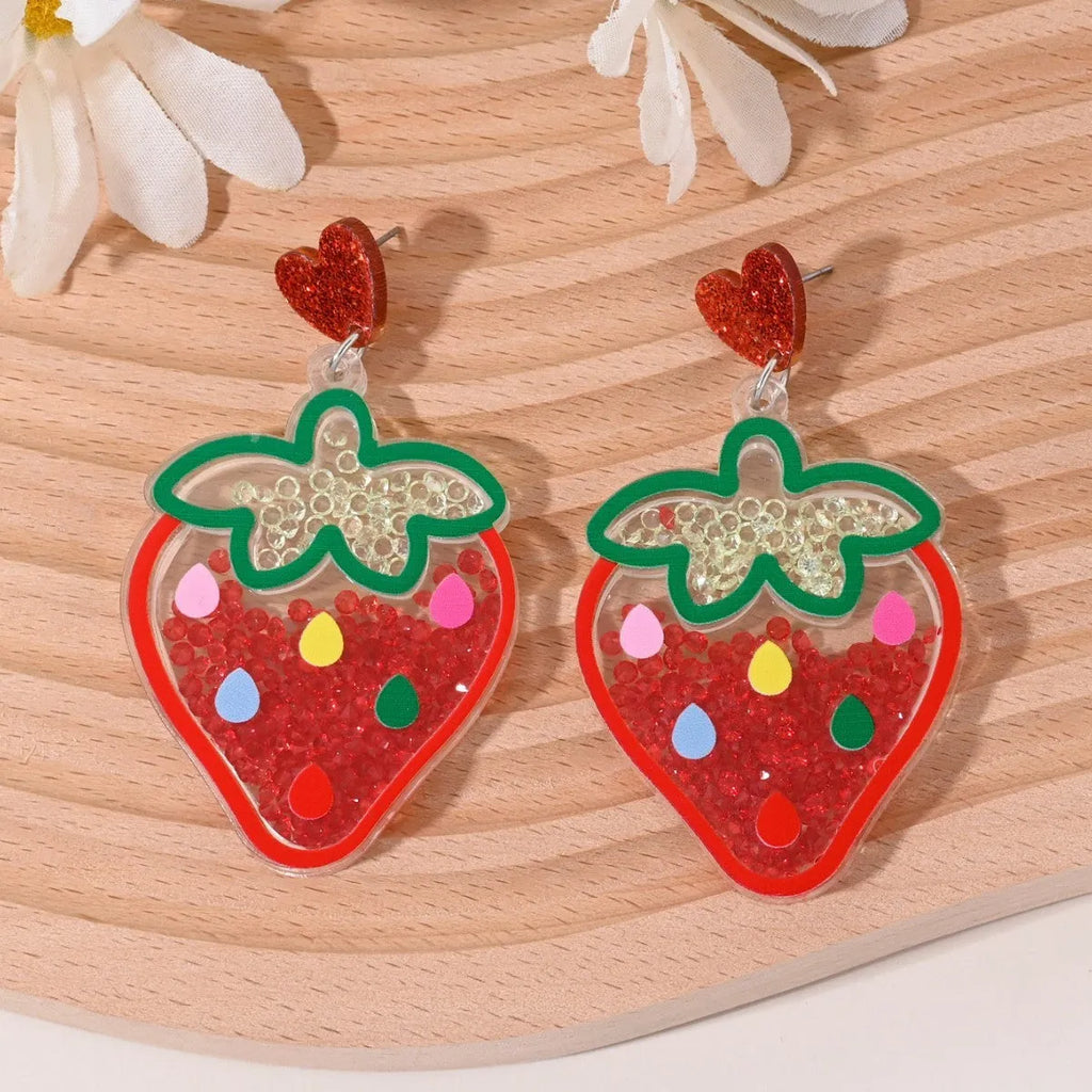 Seven pairs of colourful acrylic fruit and dessert stud earrings on a white background.
