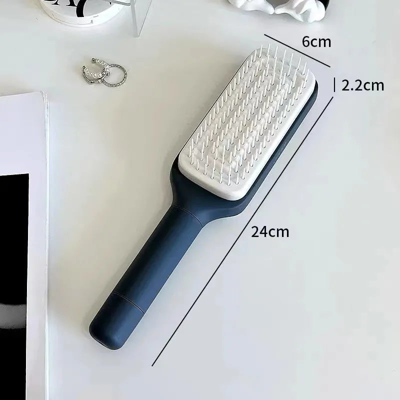 Purple self-cleaning hair brush with telescopic handle showing rotating mechanism and comb teeth