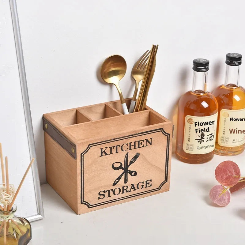 Wooden kitchen storage box with internal grid divider for organising knives, forks, and chopsticks.