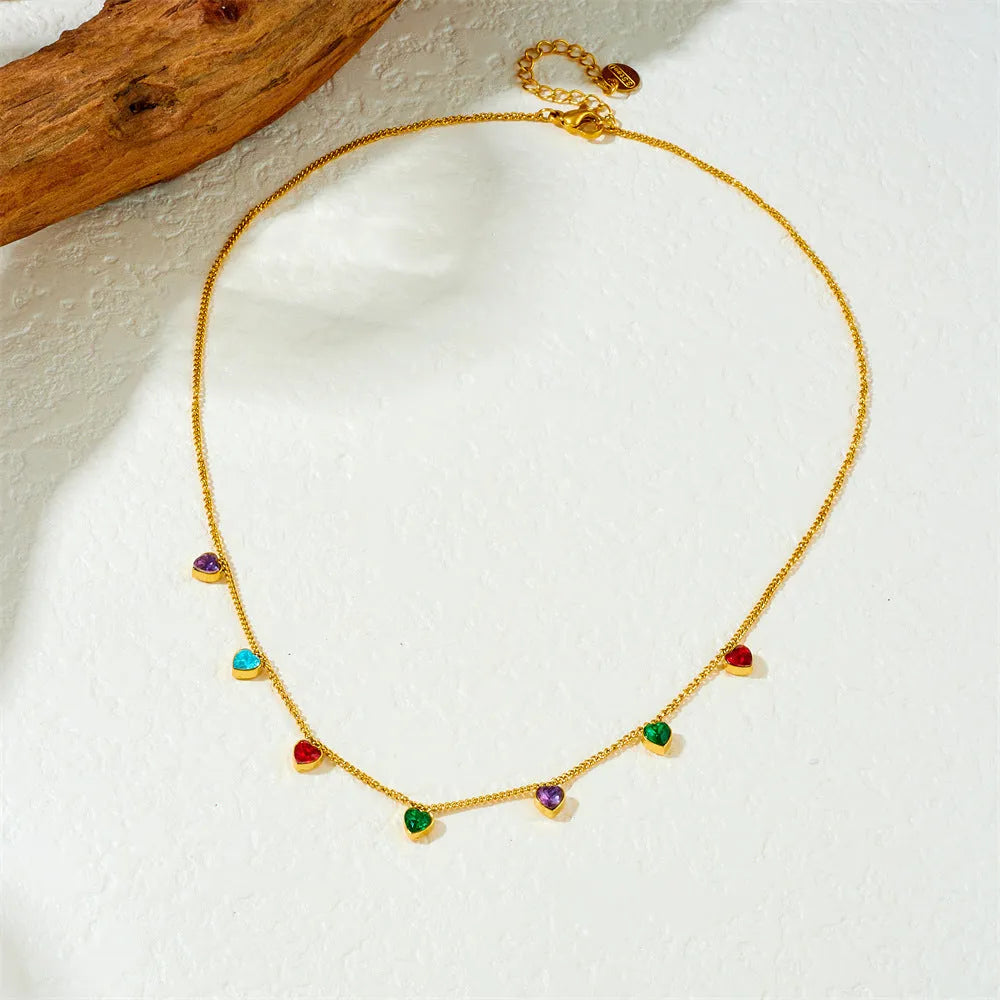 Gold-coloured stainless steel necklace with a heart pendant on an adjustable chain.