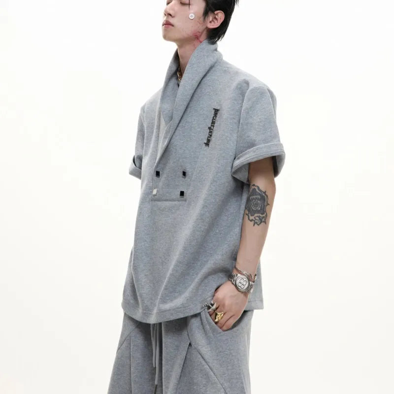 Men's dark grey V-neck sports suit with padded shoulders and metal embellishments on cotton fabric