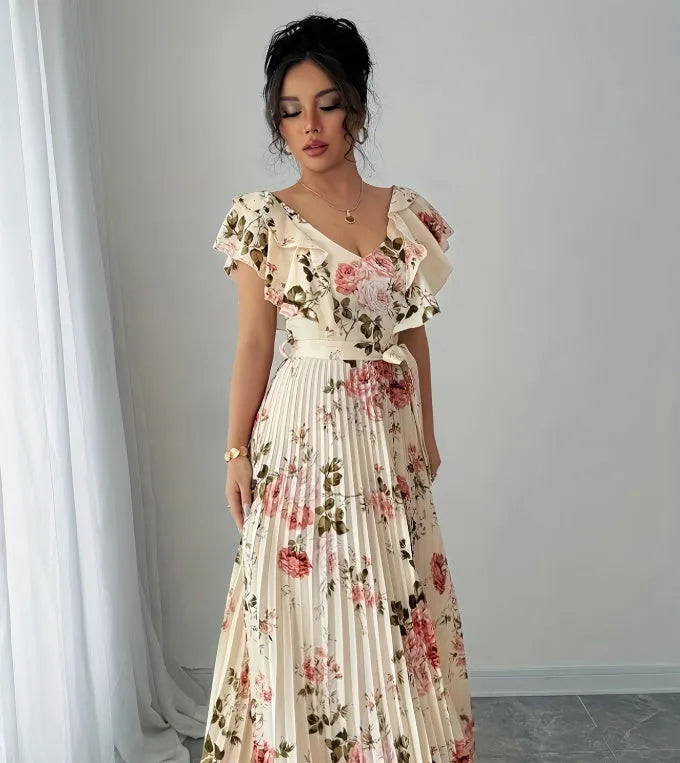 V-neck floral print dress with oversized swing skirt and ruffled sleeves in apricot colour, showing high waist and pleated details