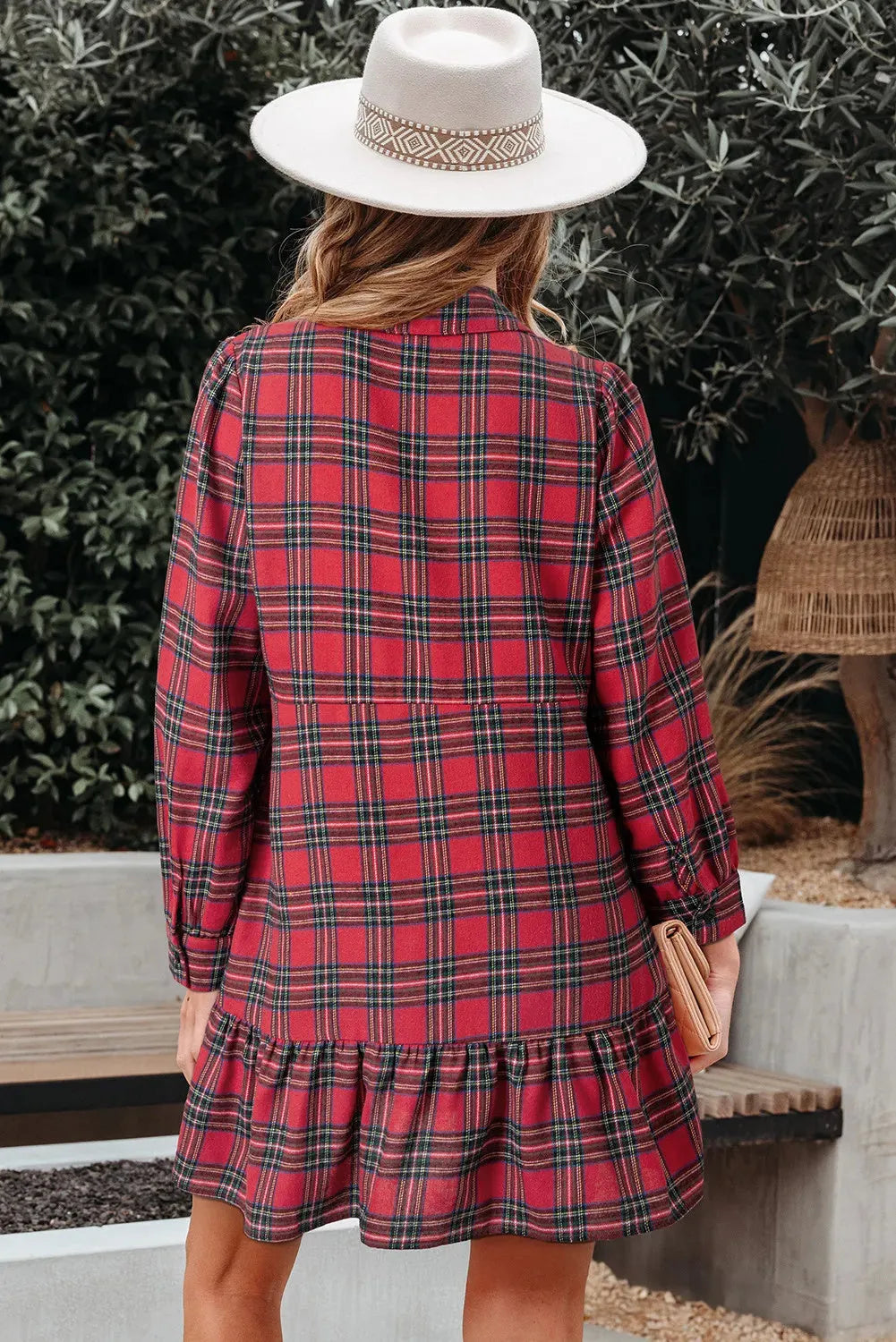 Red and black plaid mini dress with a shirt collar, half-button front, long sleeves, and a ruffle hem.