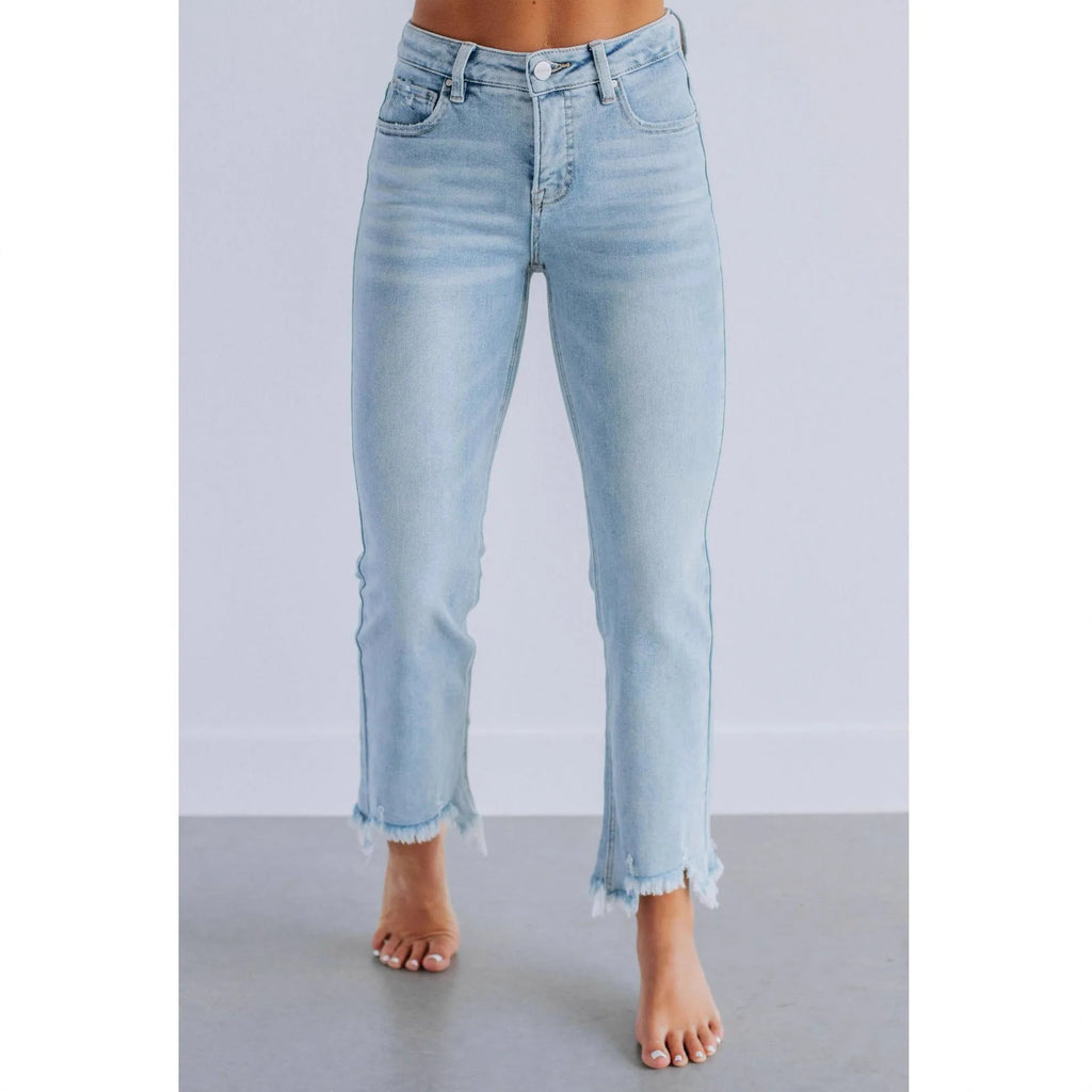 Women's hand-worn denim trousers in dark blue, showing 100% cotton fabric and casual fit