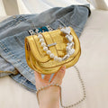 Laser Pearl Tote Saddle Girl Mini crossbody bag in gold colour showing horizontal square design and shoulder strap