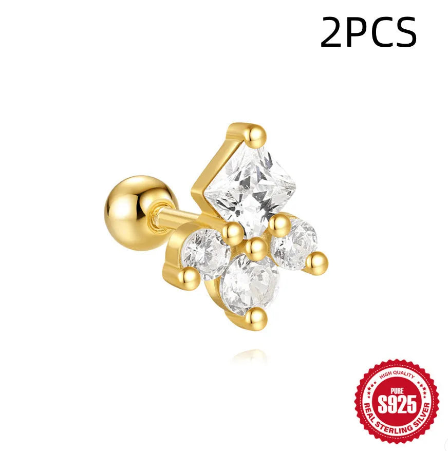 Close-up of women's sterling silver flower stud earrings with square gravel texture in a gold colour.