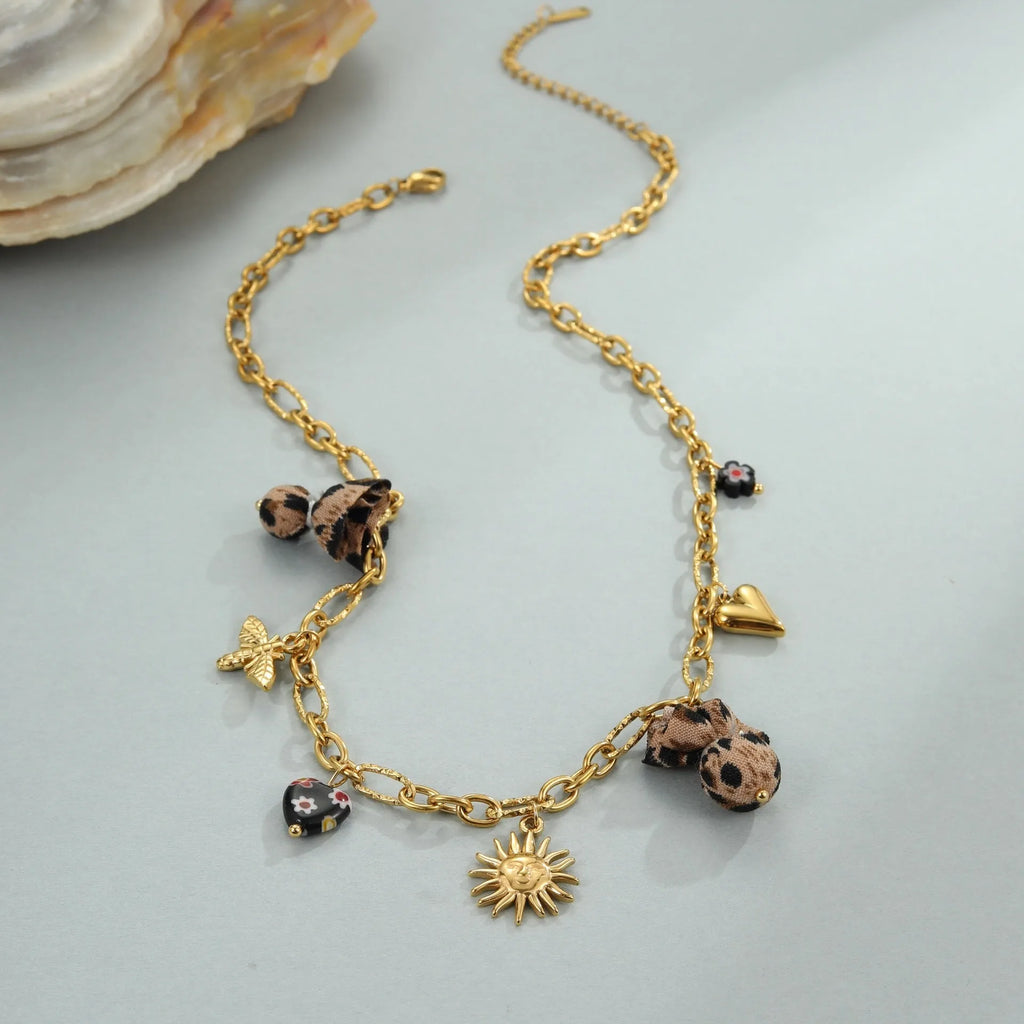 Women's gold-plated stainless steel necklace with leopard, love heart, and flowers pendant on an adjustable chain.