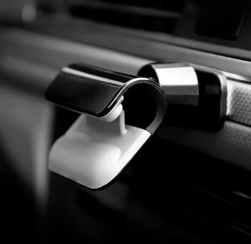 Black car phone holder showing 360-degree rotation mechanism and adhesive mounting base