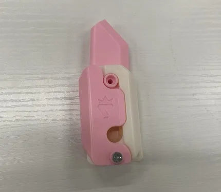 3D printed orange and green carrot-shaped gravity flick knife fidget toy on a white background.
