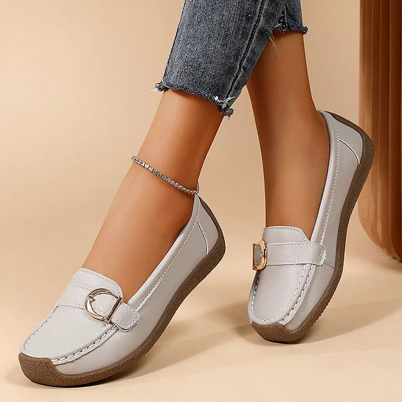 Women's beige casual loafers with round toe, flat heel, and shallow slip-on design.