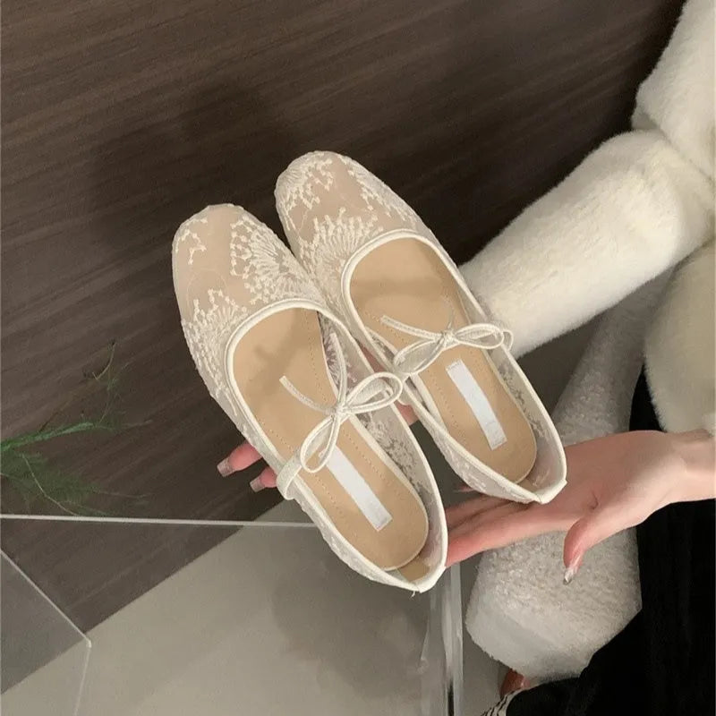 Women's flat lace mesh Mary Jane shoes in pink with a mid heel and buckle strap.