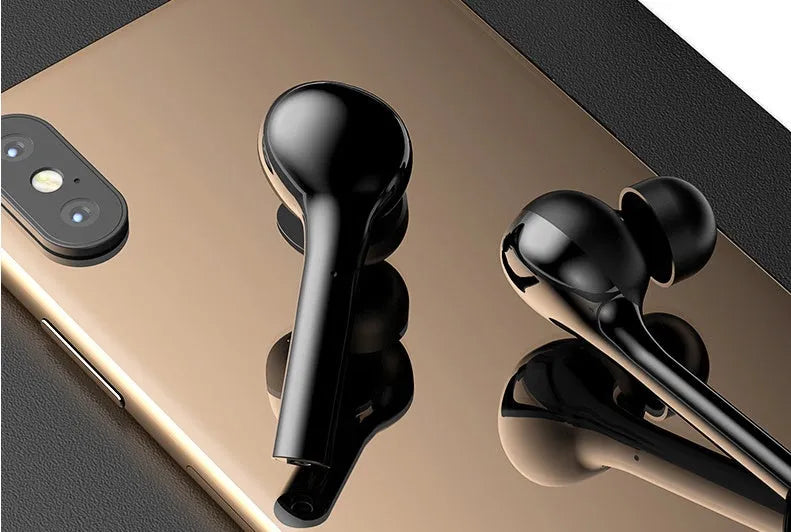 Black and white touch-controlled wireless in-ear headphones with a charging case.