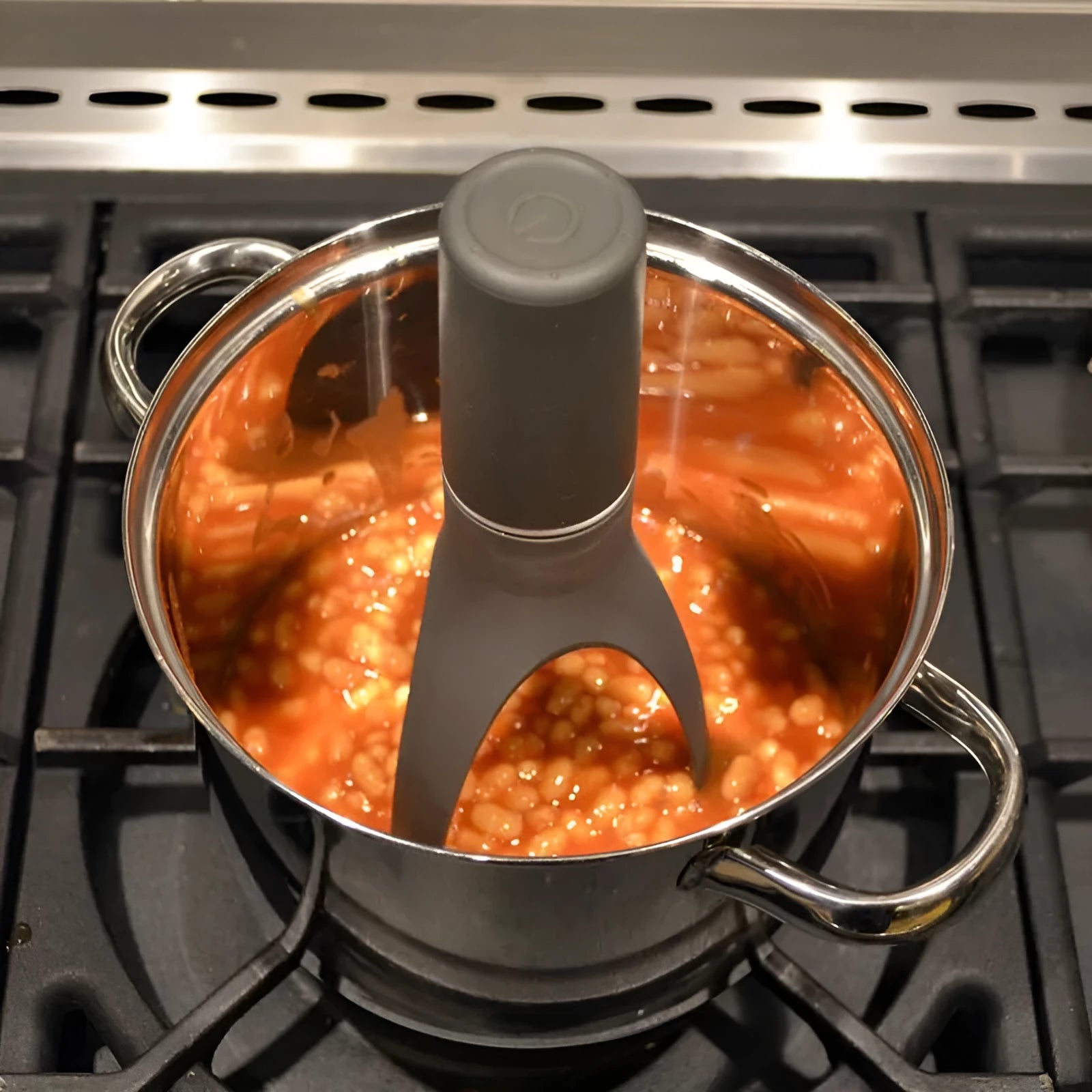 Green Uutensil Stirr automatic pot stirrer, a 22.2cm tall kitchen gadget for sauces and soups.