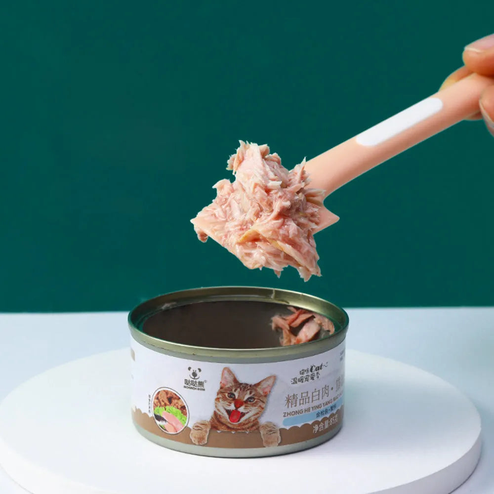 Green pet feeding spoon with 16cm handle scraping canned food from jar