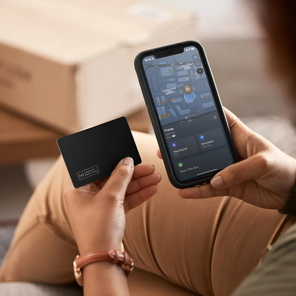 Black ultra-thin anti-loss alarm card for Apple devices on a table.