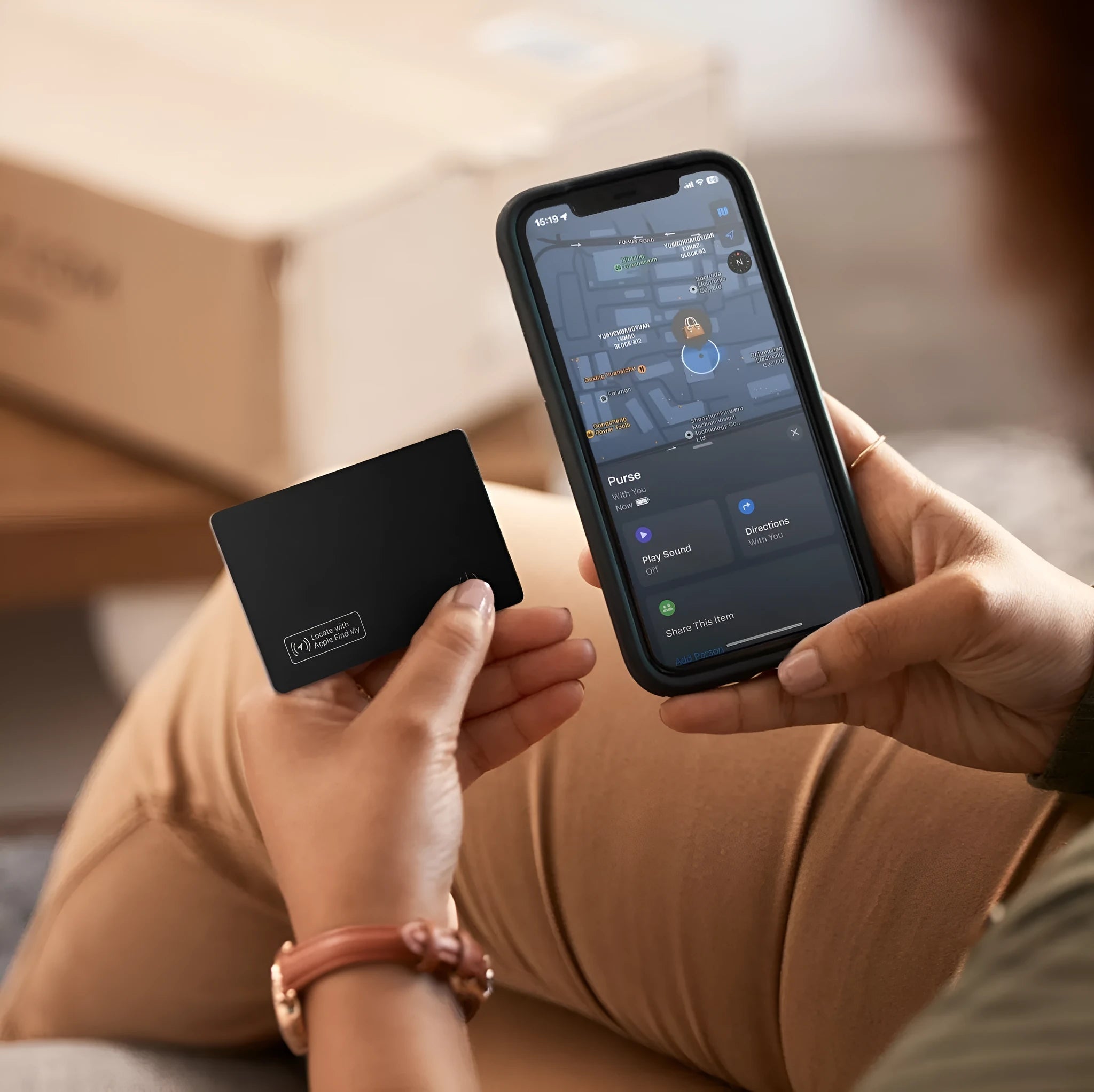 Black ultra-thin anti-loss alarm card for Apple devices on a table.