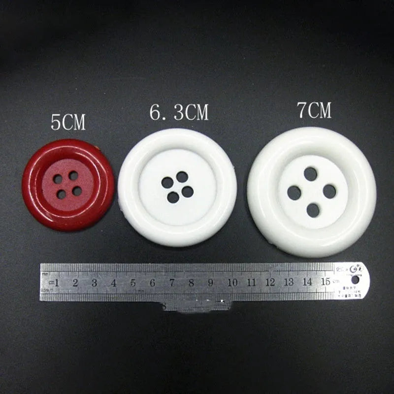 Oversized round plastic buttons with four holes in various colours and sizes from 38mm to 70mm diameter