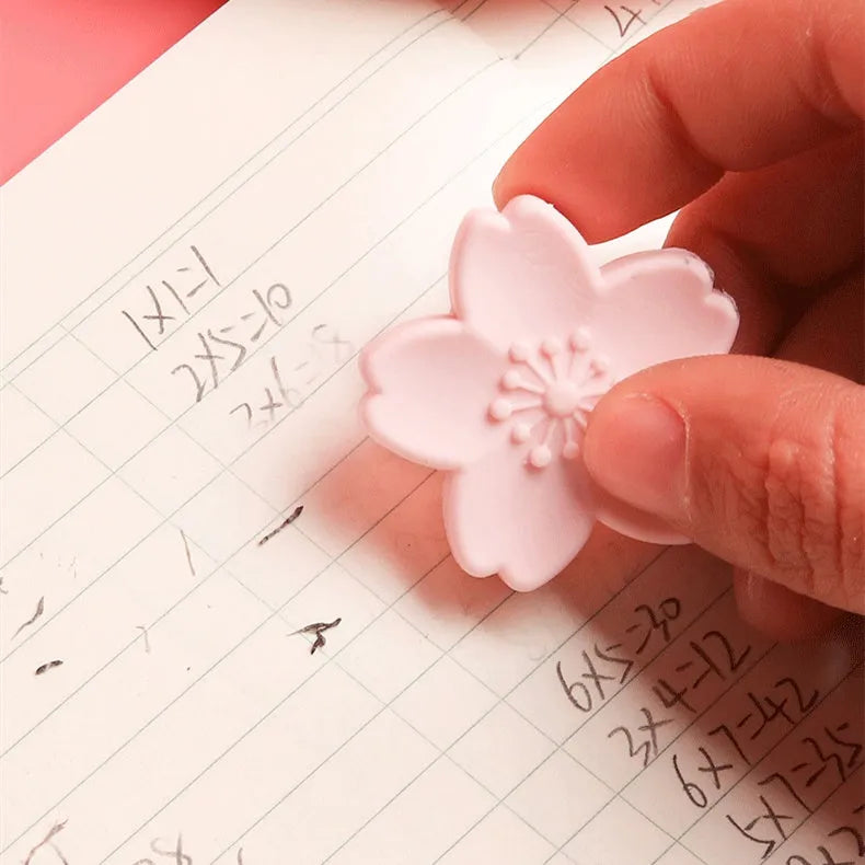 Pack of cherry blossom design student erasers on a desk, shown to leave no marks or debris.