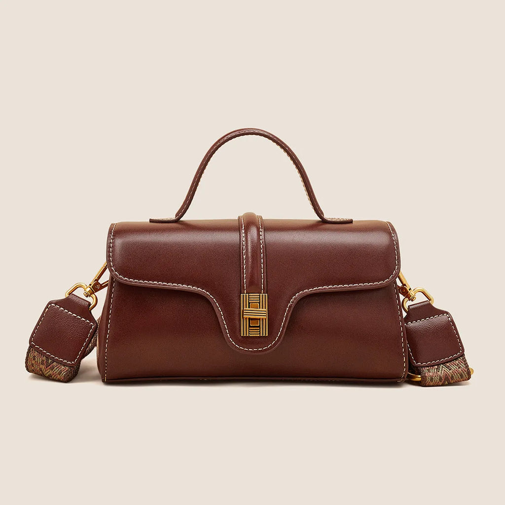 Brown Cambridge-style leather messenger bag with a front lock, shown open to reveal internal zipper pockets.