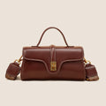 Brown Cambridge-style leather messenger bag with a front lock, shown open to reveal internal zipper pockets.
