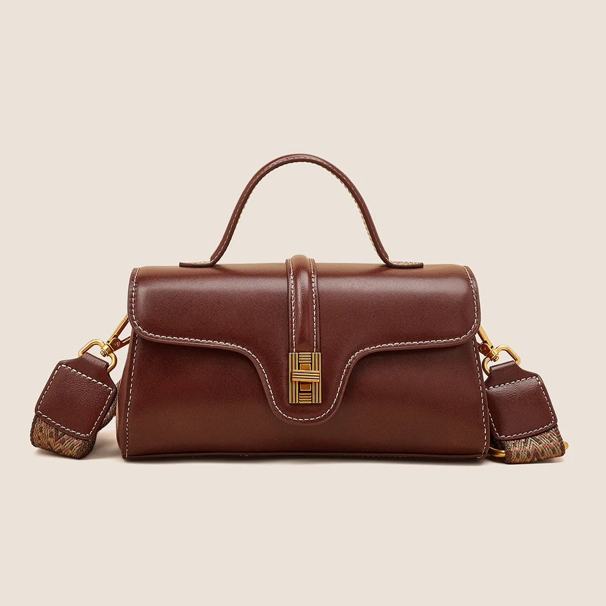 Brown Cambridge-style leather messenger bag with a front lock, shown open to reveal internal zipper pockets.