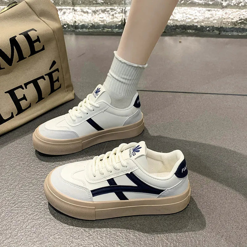 Brown and blue low-top casual board shoes with patent leather finish and round toe on a rubber sole.