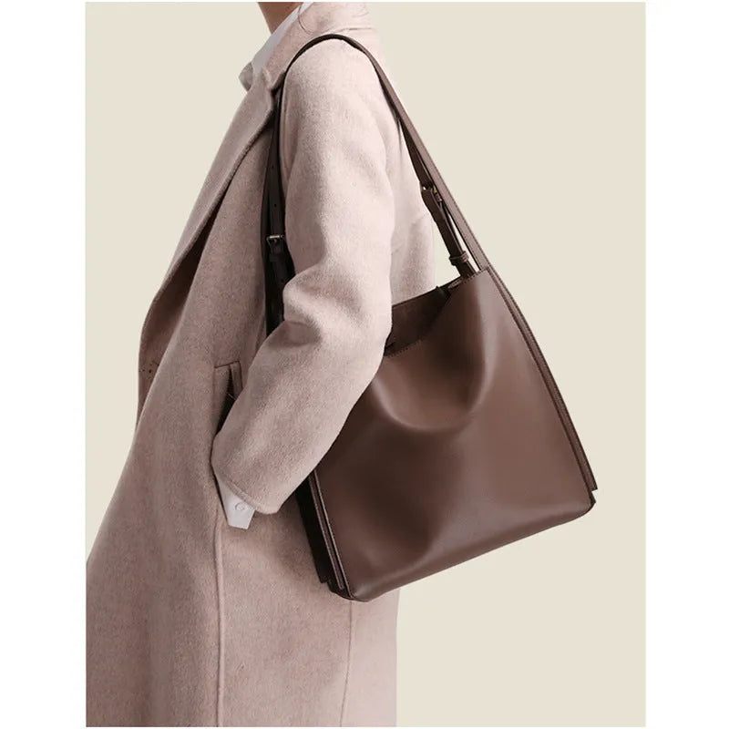 Genuine leather women's commuter bag in brown bucket design with organised internal compartments