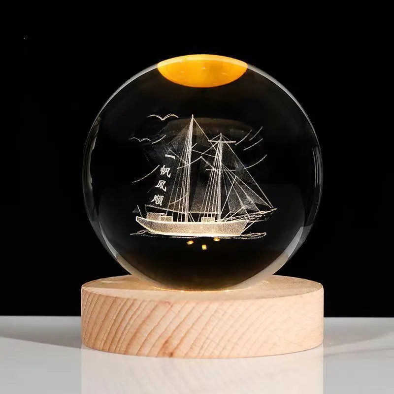 3D crystal ball night light projecting starry sky and planets from its 6cm sphere on a solid wood base.