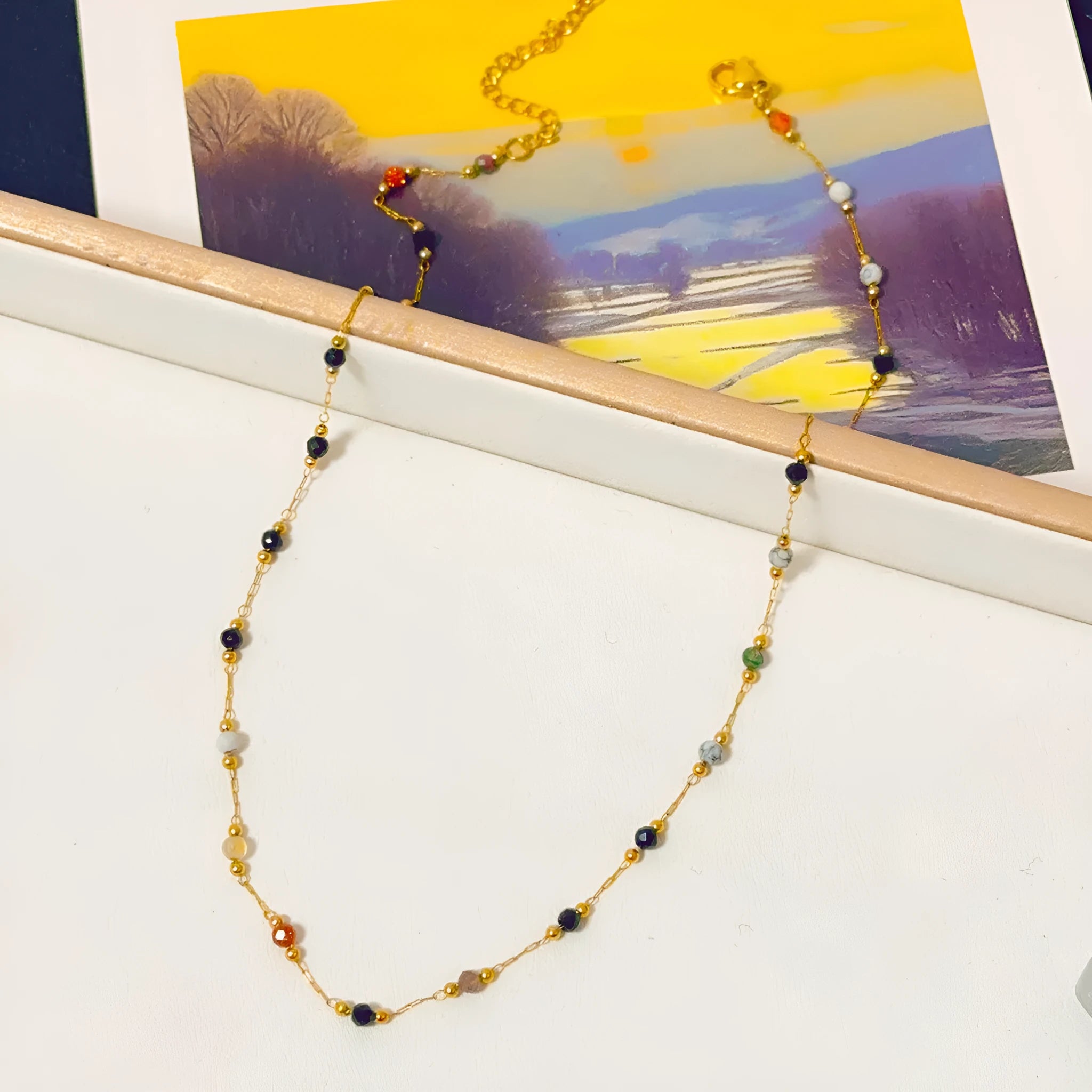 Women's gold titanium steel necklace with a simple natural stone pendant on an O-ring chain.