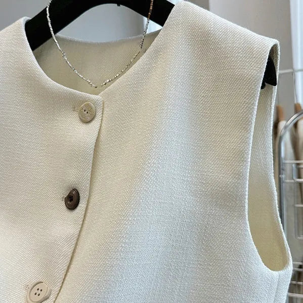 French style round neck sleeveless vest in milky white colour, showing bandage-style construction and polyester fabric texture