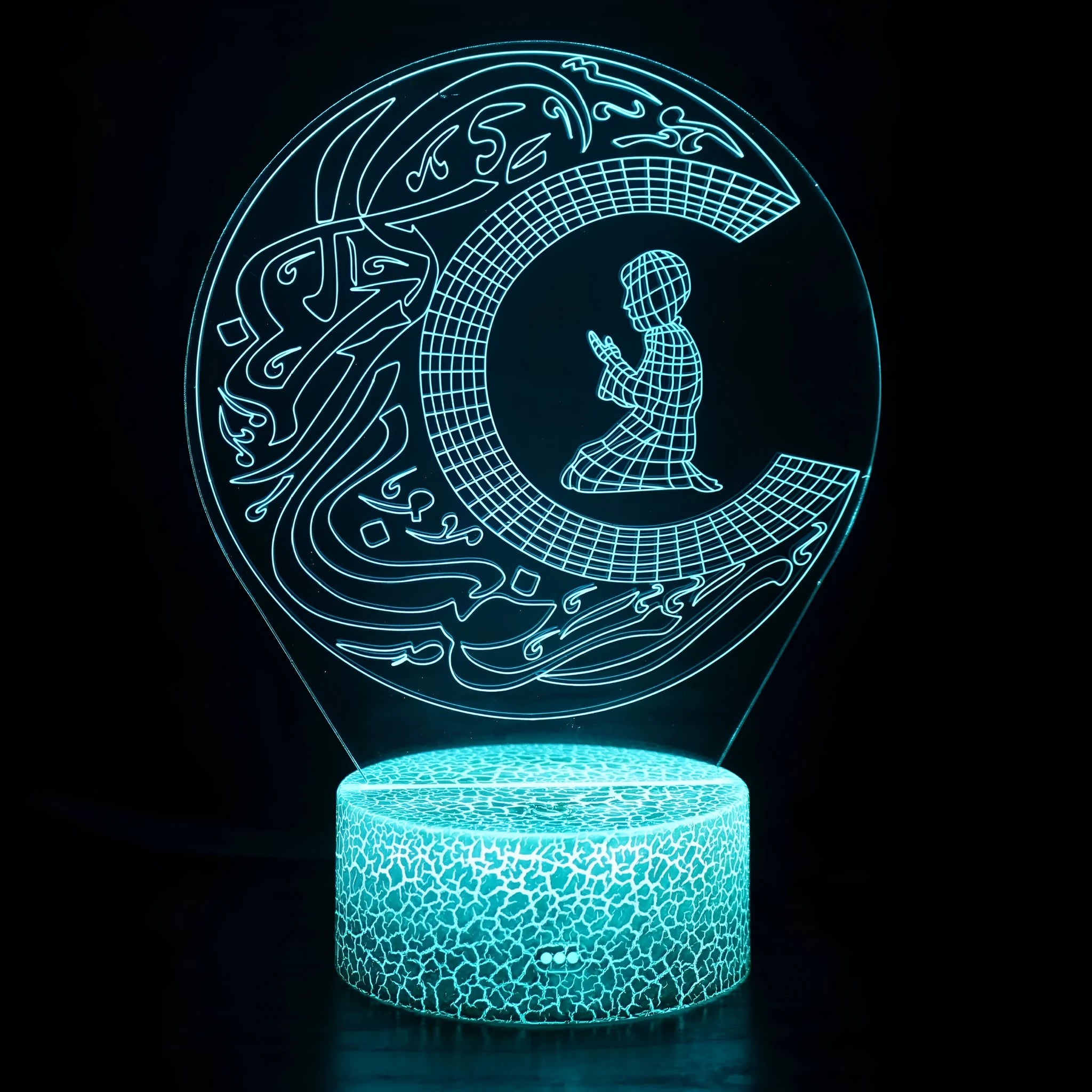 Cartoon-style 3D LED night light with black touch base and remote control on a bedside table.